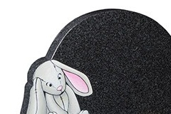 This circular headstone is further shaped around the sandblasted and painted bunny - shown in flint grey granite.headstone 16" (h) x 22" (w) x 3" (d)Base 3" (h) x 24" (w) x 12" (d)Product code -  16176